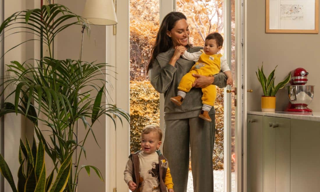 mãe e filhos a entrar em casa com roupas prénatal amarelas e verde tropa a condizer